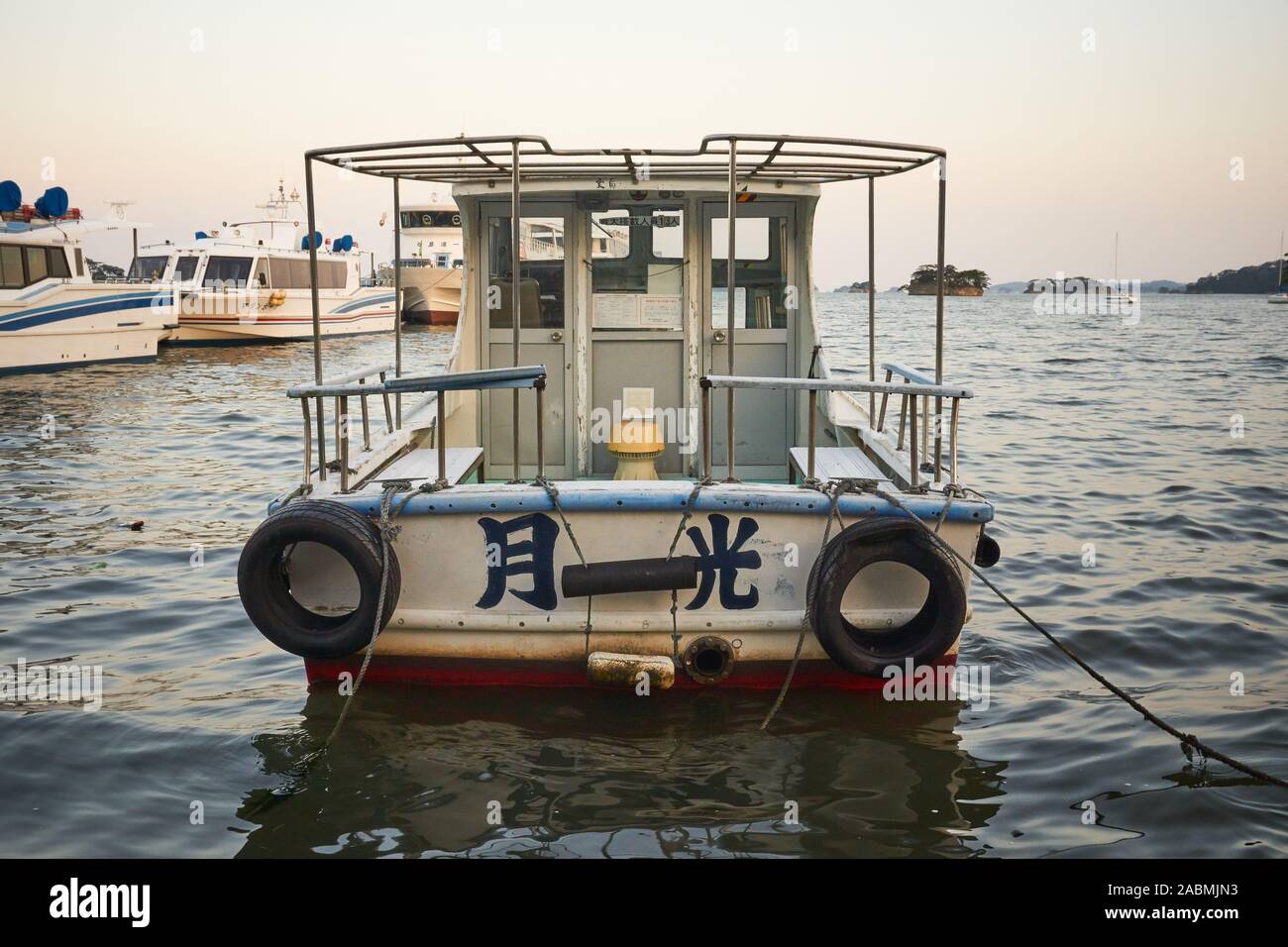 A Boat called Gekkou (Moonlight) is roped down and docked at Matsushima Bay at dusk in Matsushima, Miyagi, Japan. Stock Photo