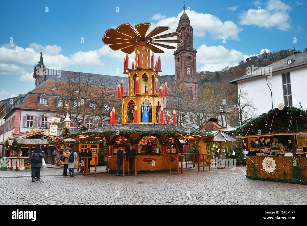 Heidelberg, Germany - September 2019: Massive holiday pyramid with candles as part of traditional Christmas market on universiry square in city Stock Photo