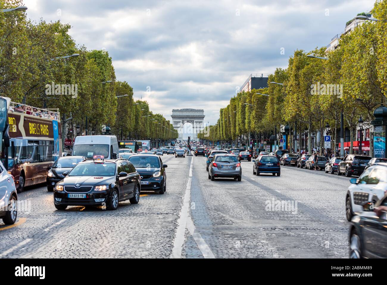 Street view of Champs-Elysees Avenue with Arc de Triomphe in Paris