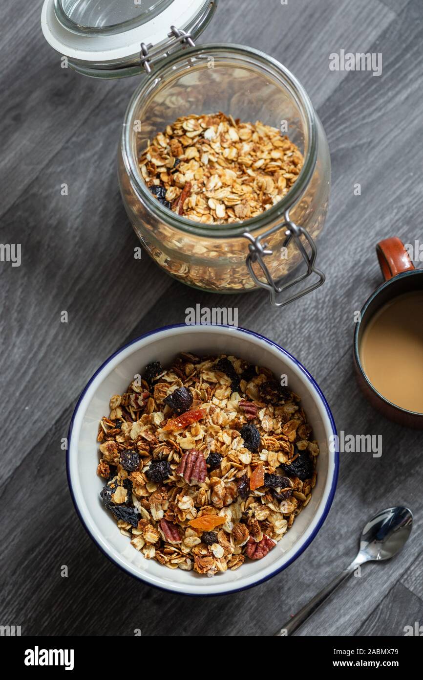 Fruit Granola Cereal Breakfast Bowl with Milk on Wooden Background Stock Photo