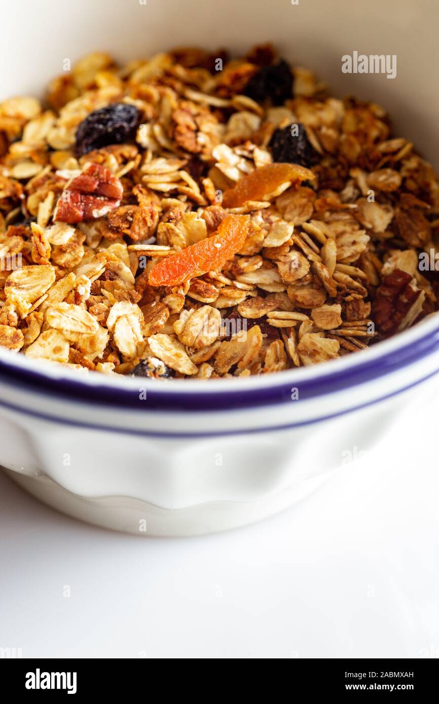 Fruit Granola Cereal Breakfast Bowl with Milk on Wooden Background Stock Photo