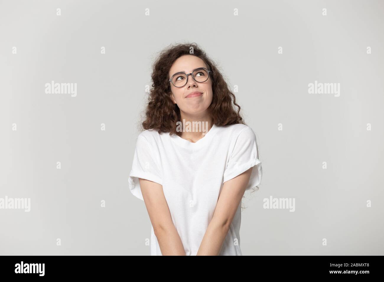 Happy teenage girl in glasses look up visualizing Stock Photo - Alamy