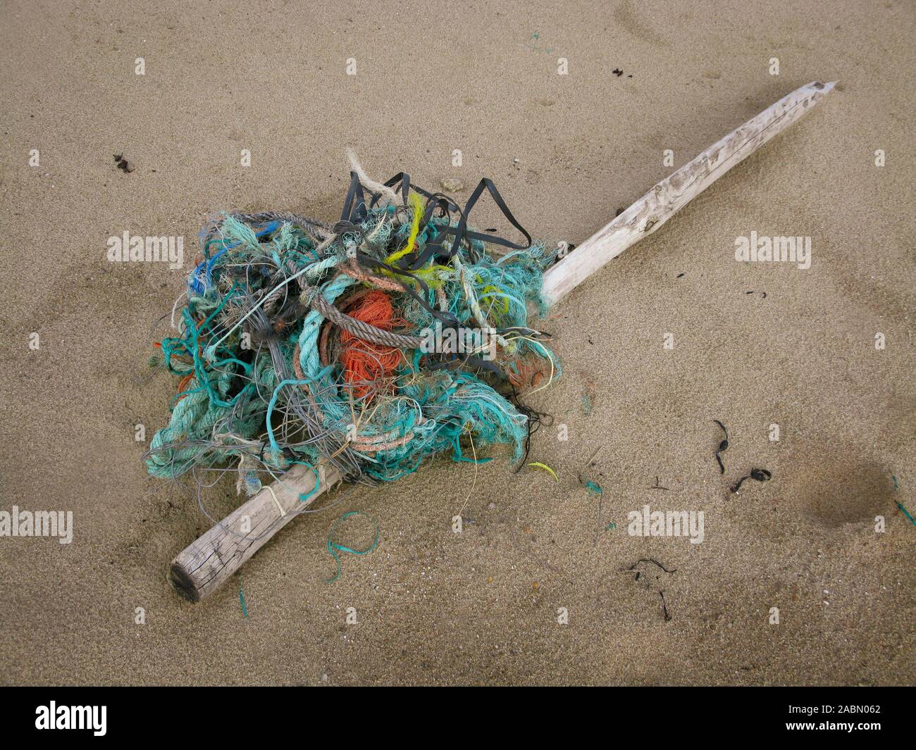 Discarded rubbish, fishing net, a wooden post and debris washed onto the sand, Bretignolles-sur-Mer, Vendee, South west France Stock Photo