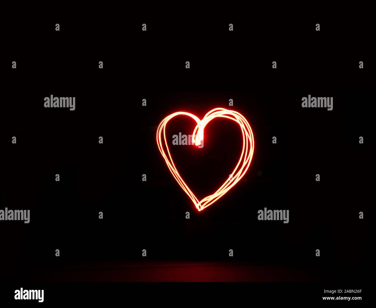 Long exposure heart red colour outline outside sign light painting Stock Photo