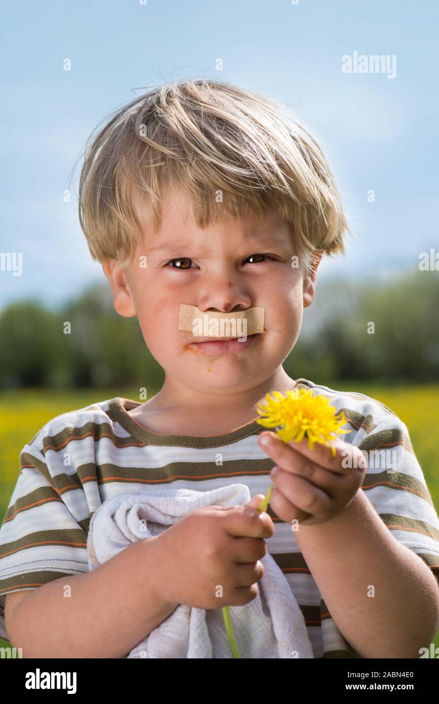 Little boy with a peg under his nose Stock Photo