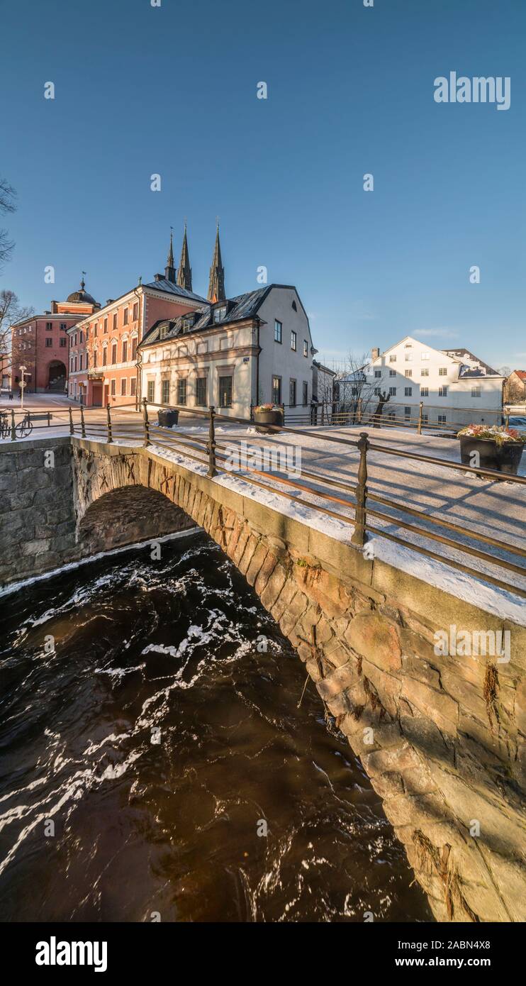 The old Dombron stone bridge at Kvarnfallet in the Fyris river in the winter. Uppsala, Sweden, Scandinavia Stock Photo