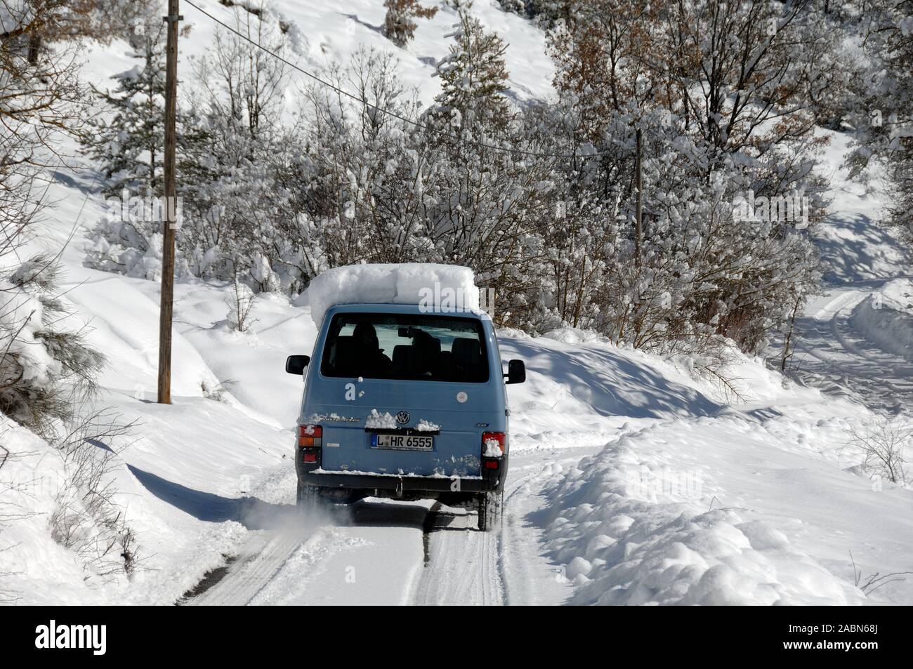 Car Driving on Packed Snow or Snowy Country Road Blieux Alpes-de-Haute-Provence Provence France Stock Photo