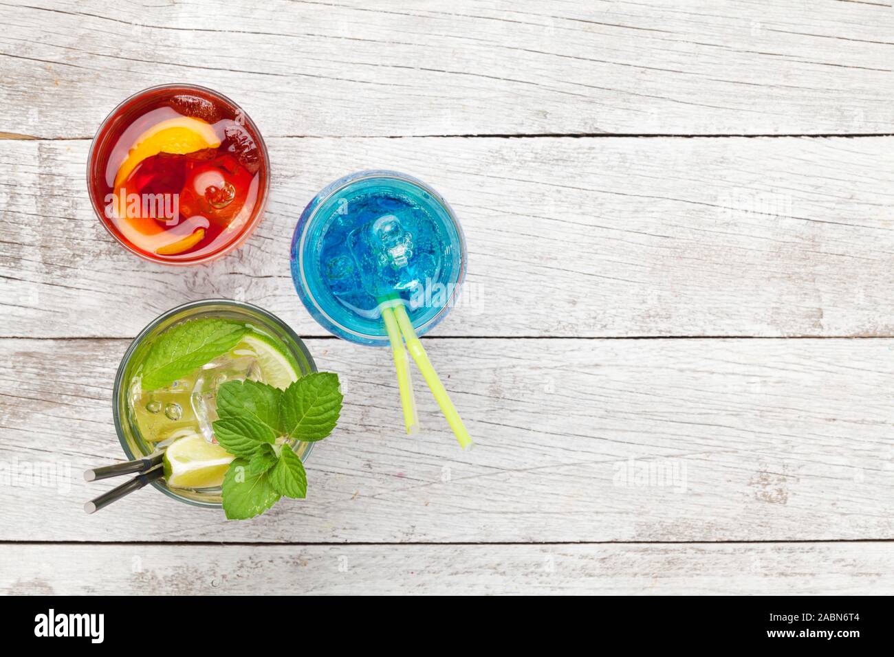 Three Classic Cocktail Glasses On Wooden Table Negroni Blue Lagoon And Mojito Top View With Copy Space Flat Lay Stock Photo Alamy