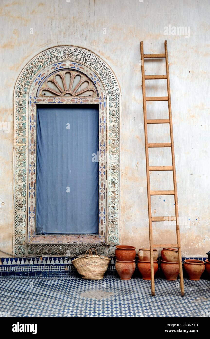 Still Life with Ornate Oriental Door, Ladder & Terracotta Pots in Dar El Glaoui Palace, early c19th, Fez or Fes Morocco Stock Photo