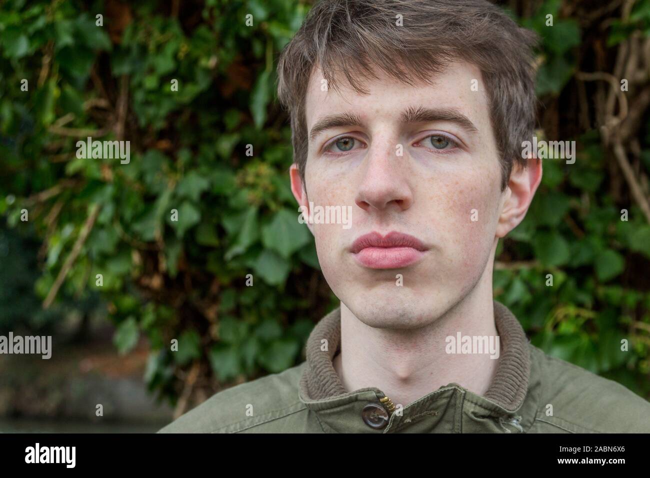 Outdoor portrait of a handsome young man wearing casual clothing. Aged in his late teens or early twenties. Stock Photo