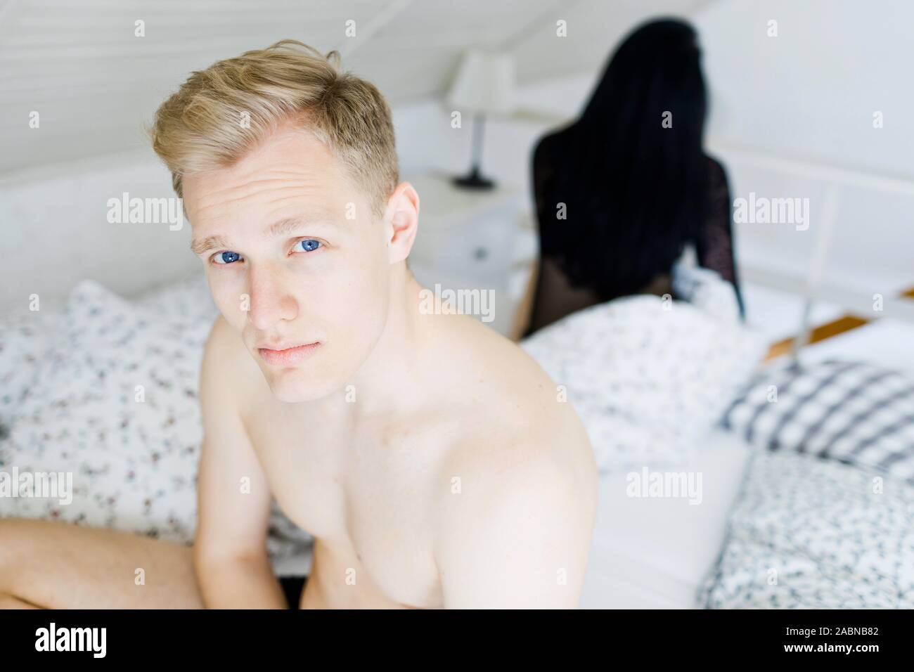 Young couple having problems in bed. Man and woman bother during intimate moments in bedroom. Stock Photo