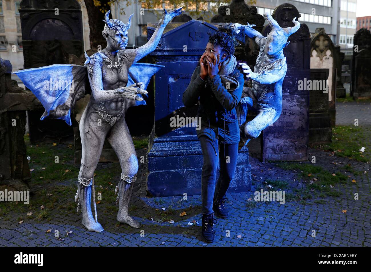 Hannover, Deutschland. 28th Nov, 2019. GEEK ART - Bodypainting and Transformaking: Gargoyle photoshooting with Enrico Lein, Marlena Wieland and Clementine Hoegnifio at the Nikolai graveyard in Hannover on November 28, 2019 - A project by the photographer Tschiponnique Skupin and the bodypainter Enrico Lein Credit: Geisler-Fotopress GmbH/Alamy Live News Stock Photo