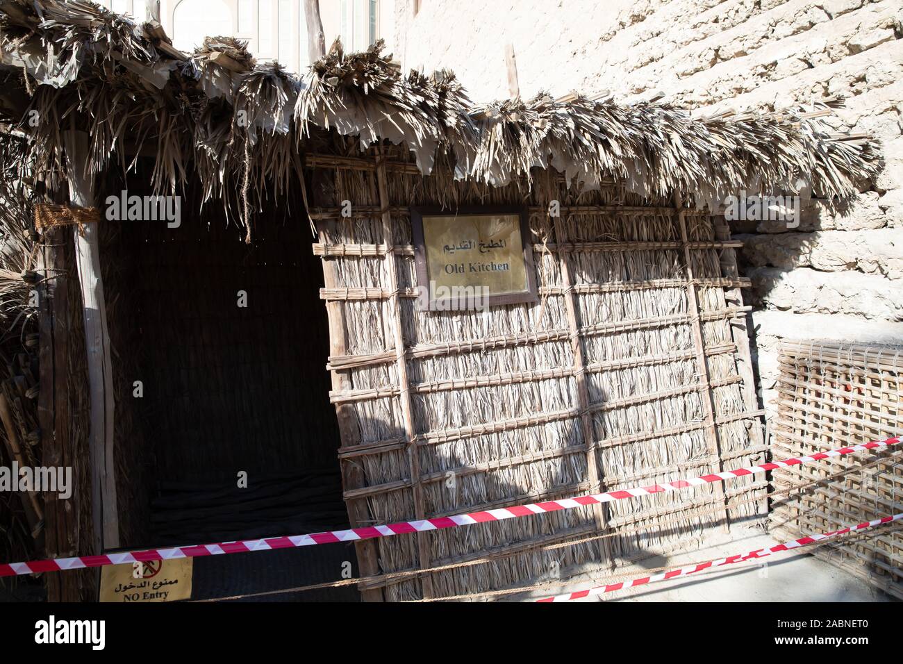 An old wicker house in Dubai Museum, Dubai,UAE surrounded by red and