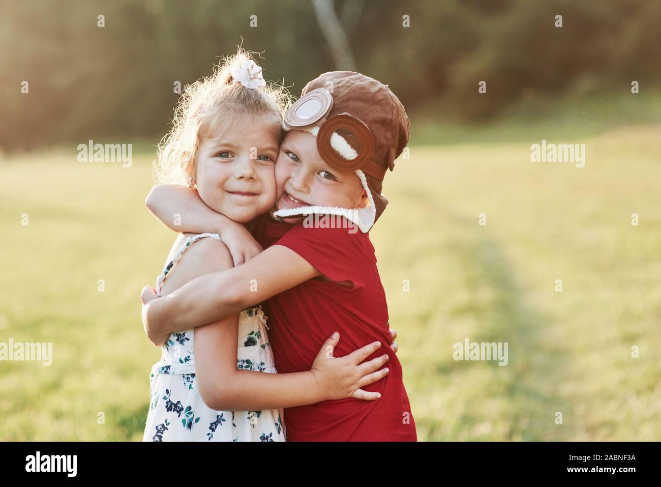 Two cute kids hugging each other outside, near the beautiful woods Stock  Photo - Alamy