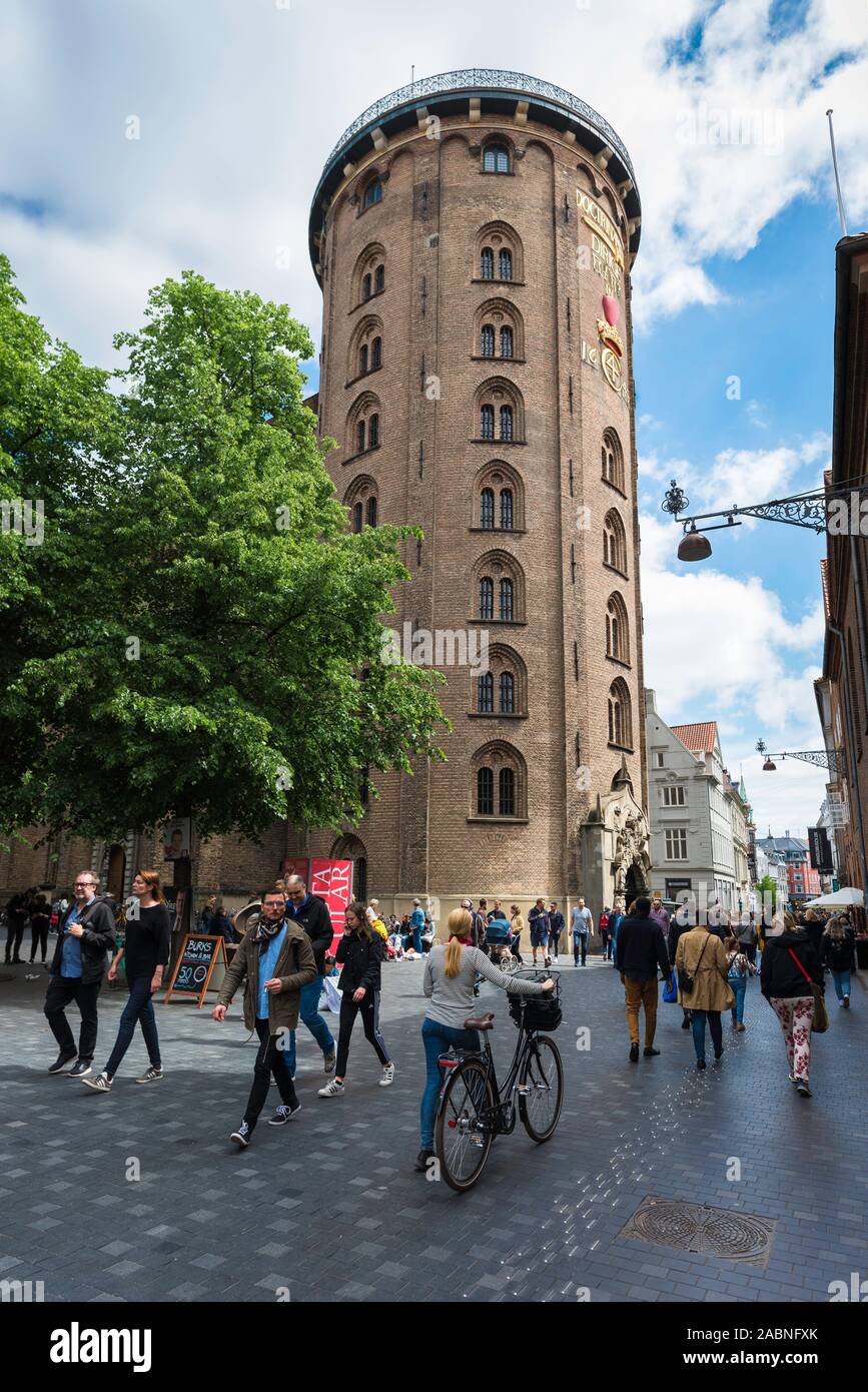 Round Tower Copenhagen, view of the landmark Rundetaarn building with people walking along Kobmagergade in central Copenhagen, Denmark. Stock Photo