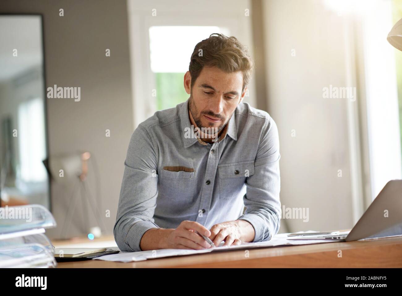 Modern man working in office Stock Photo - Alamy