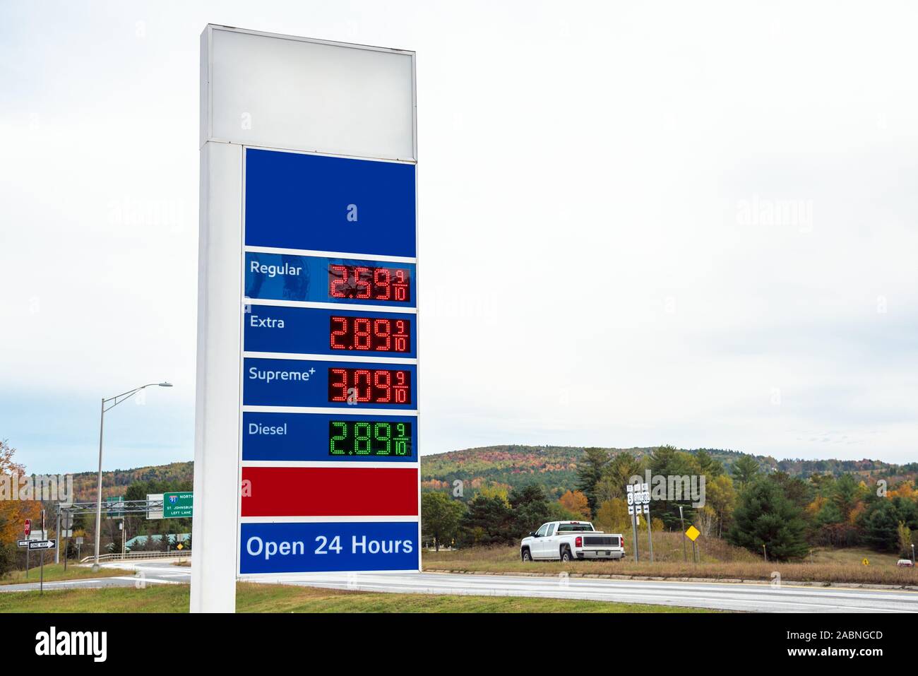 Petrol station sign with prices along a highway on a cloudy autumn day Stock Photo