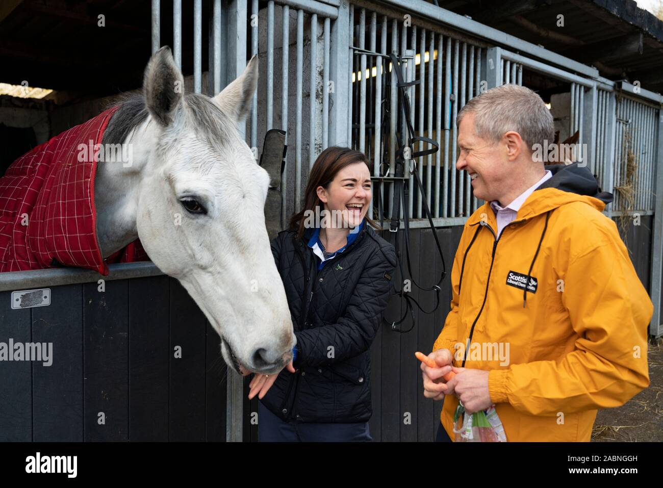 Lasswade, Scotland, UK. 28th November 2019. Liberal Democrats  highlight “two horse race in many seats” at Lasswade horse riding school. Scottish Liberal Democrat Leader Willie Rennie and candidate for Berwickshire, Roxburgh & Selkirk, Jenny Marr, visited the Lasswade riding centre to highlight the Lib Dems’ place as the lead contender in many seats across Scotland. Iain Masterton/Alamy Live News. Stock Photo