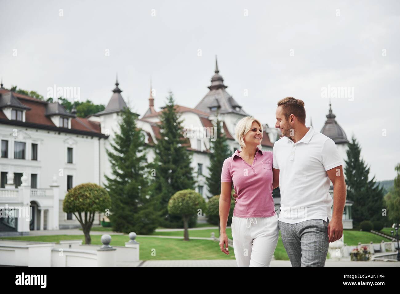 A handsome couple, man and a woman walking together holding hands. The concept of middle-aged relationships Stock Photo