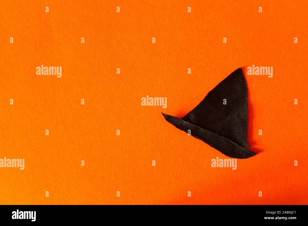Halloween concept image. Witch hat on orange background Stock Photo - Alamy