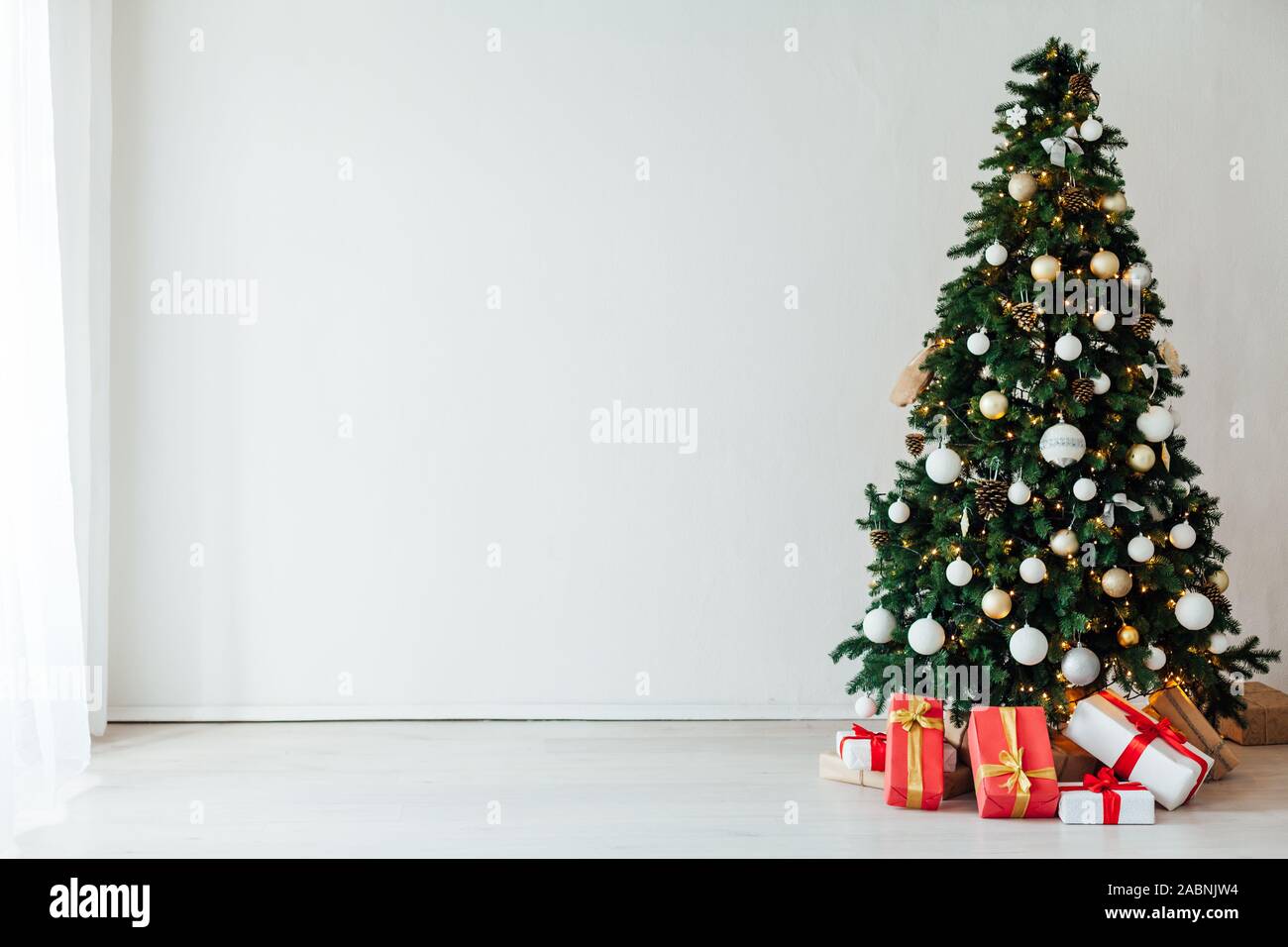 Christmas tree with gifts decor in the interior of the white room as a ...