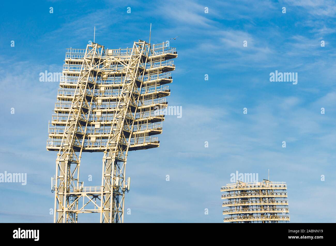 Stadium lights towers in the daytime against blue sky Stock Photo