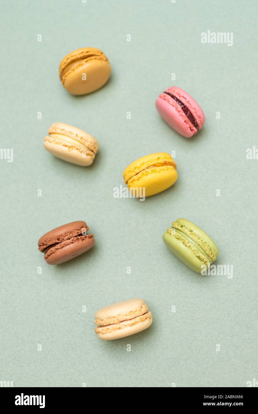 Colored tasty  macaroons over a green background. Stock Photo