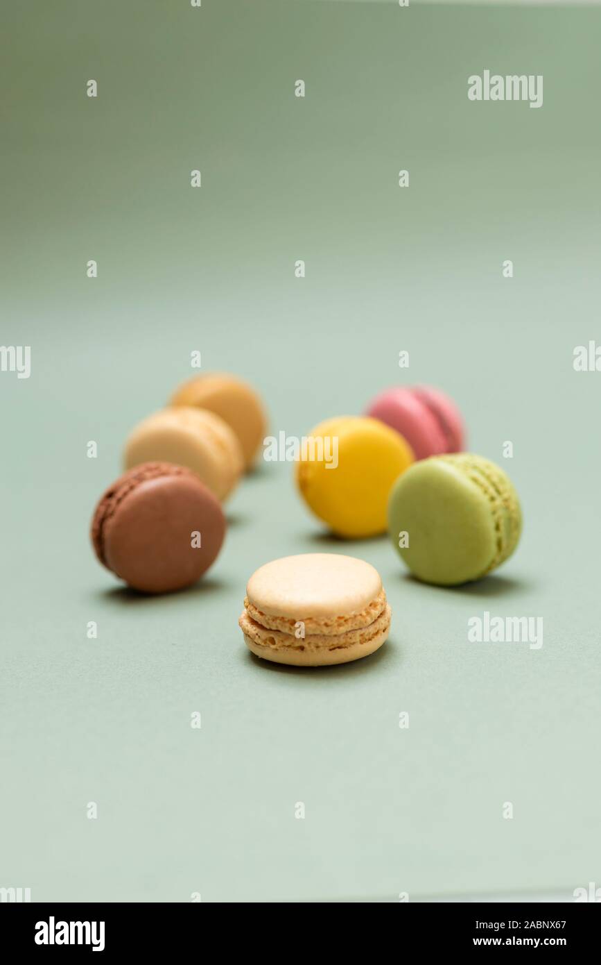 Colored tasty  macaroons over a green background. Stock Photo