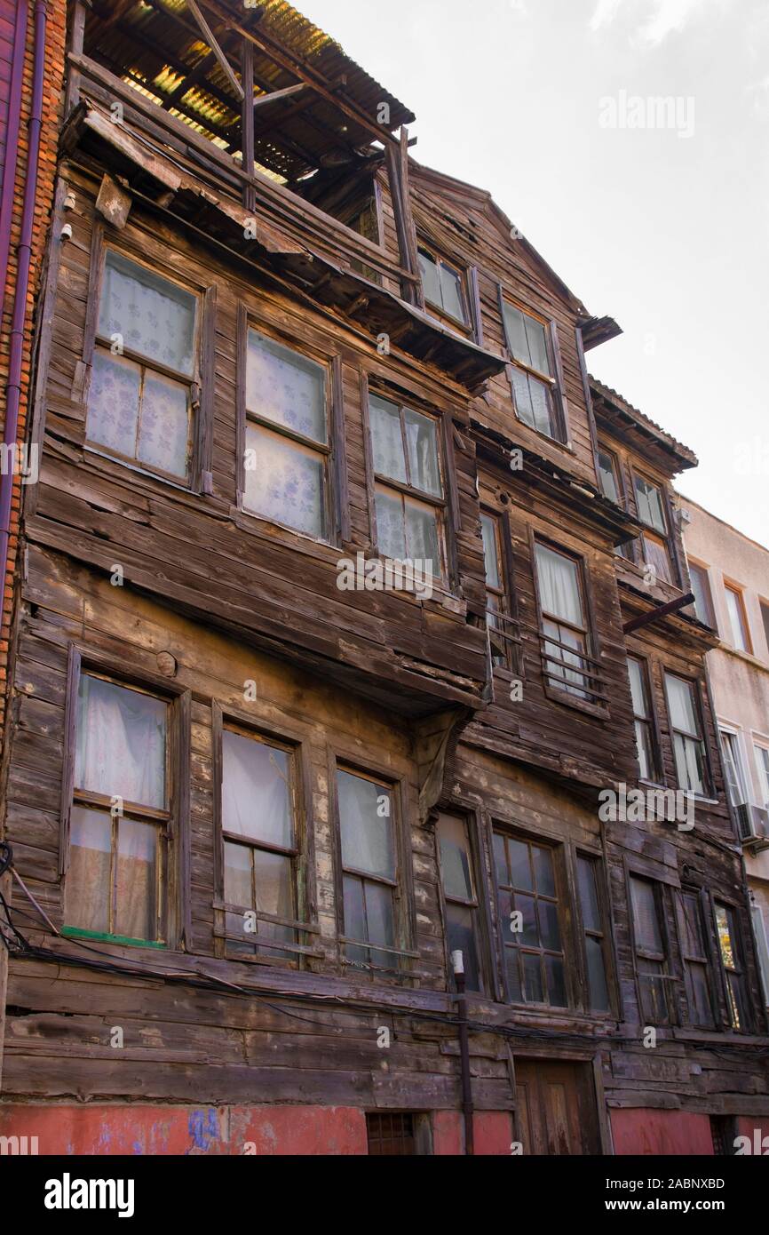 Traditional historic wooden buildings stand semi-derelict in the Zeyrek district of Fatih, Istanbul Stock Photo