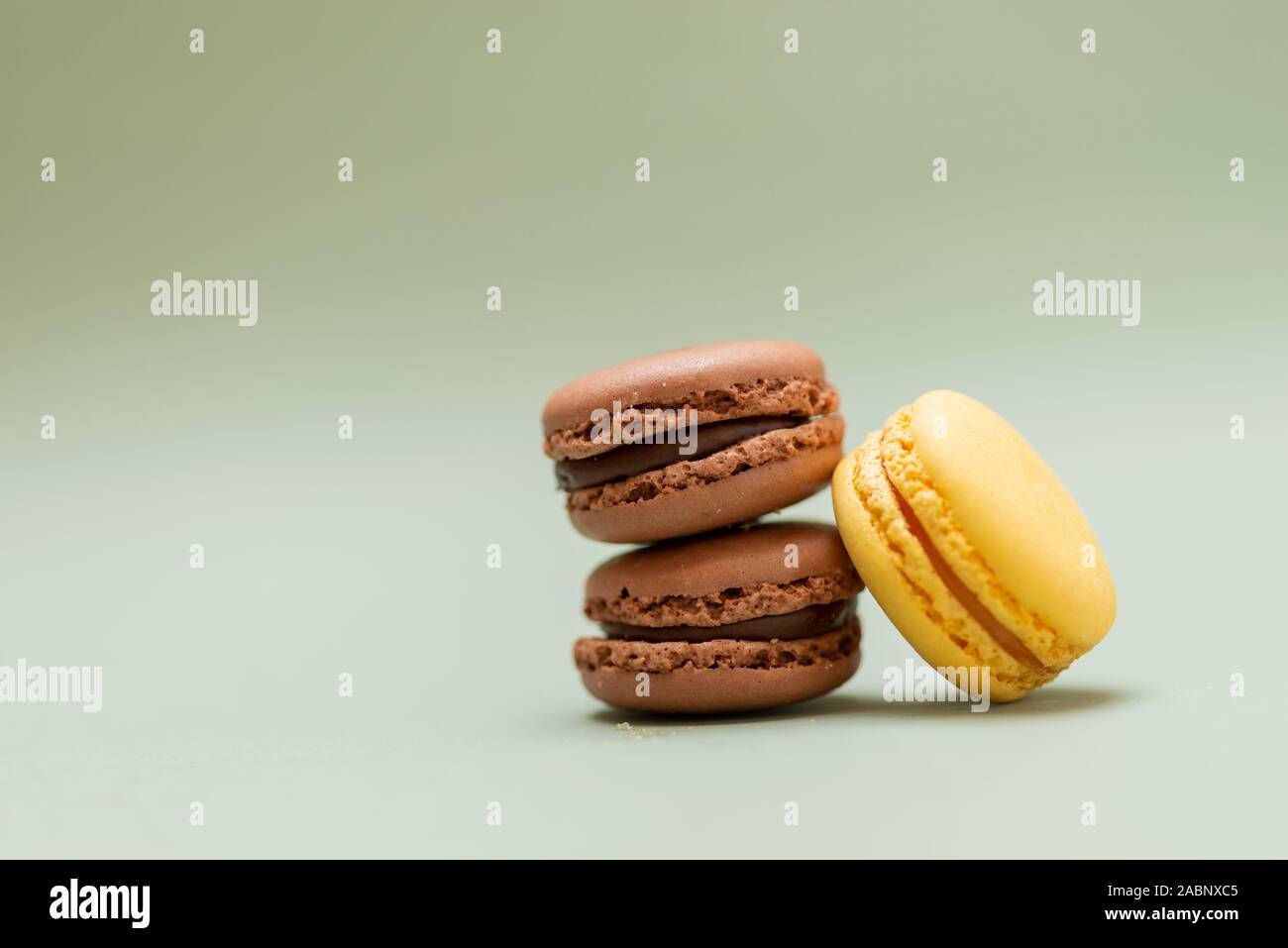 Colored tasty  macaroons over a green background. Stock Photo