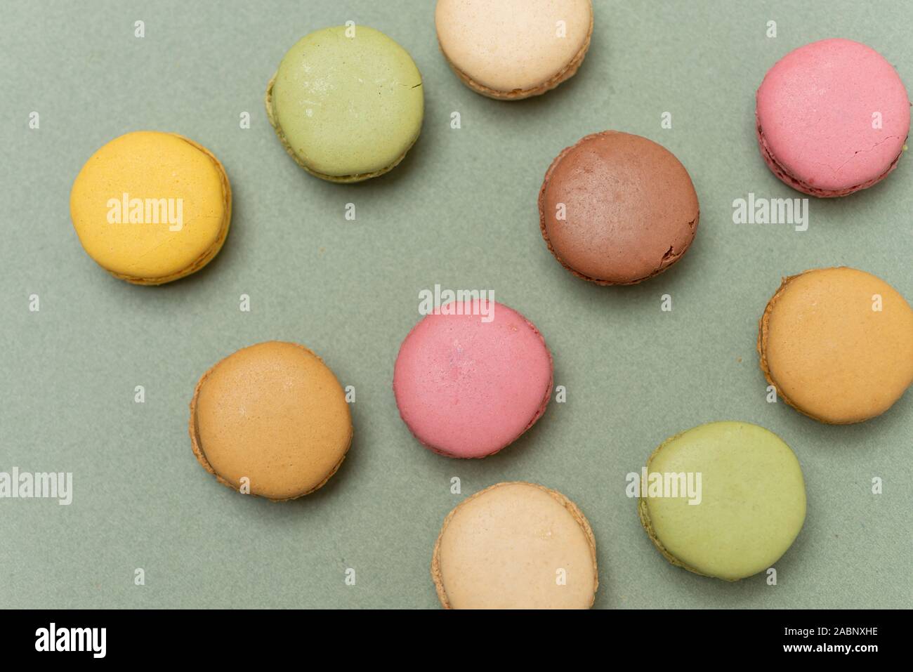 Colored tasty  macaroons over a green background. Stock Photo