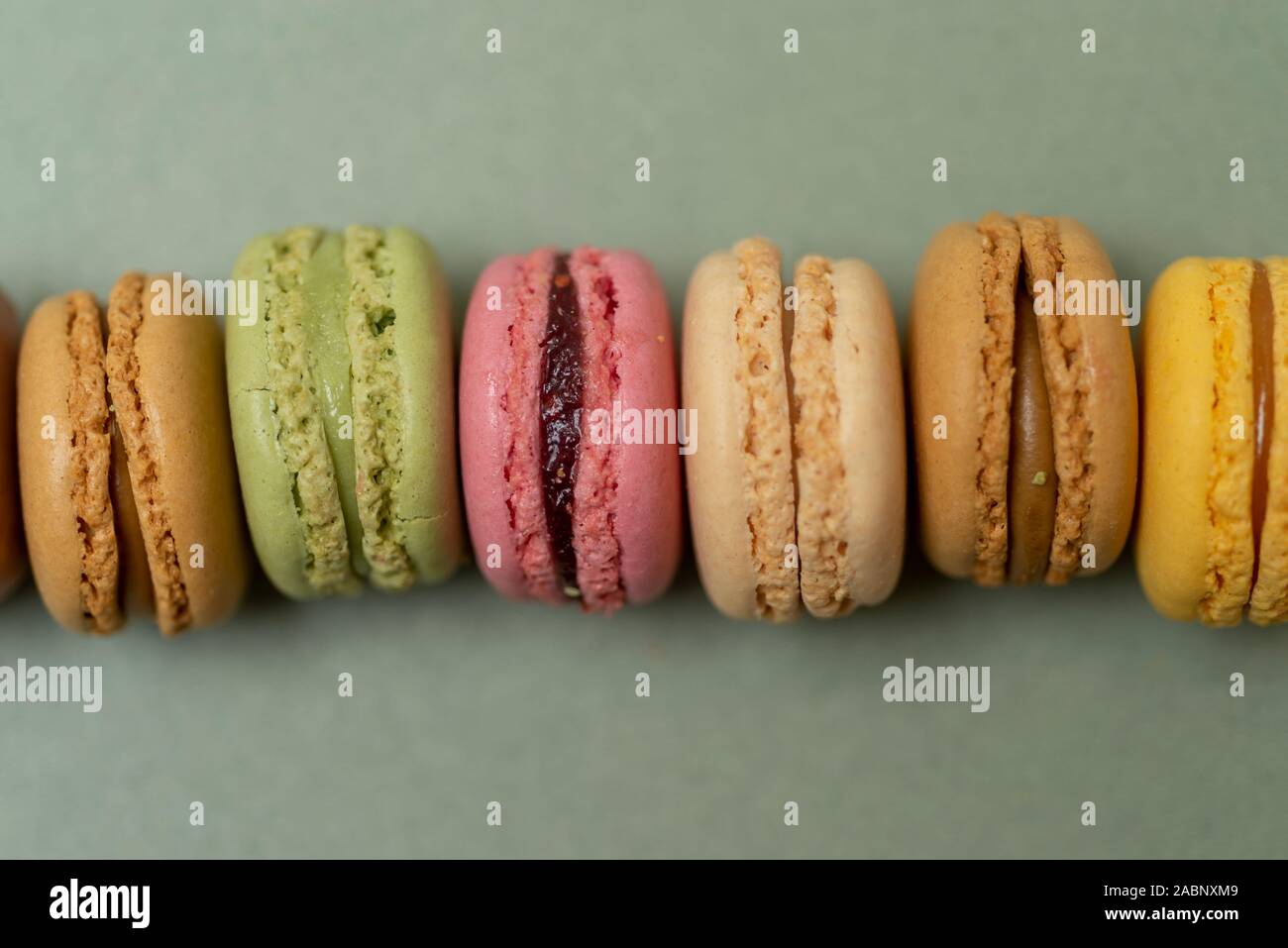 Colored tasty  macaroons over a green background. Stock Photo
