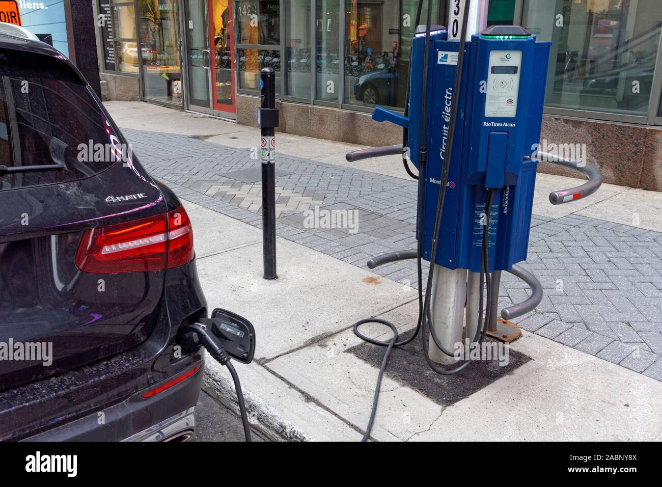 An electric car at an EV charging station in downtown Montreal, Quebec, Canada Stock Photo