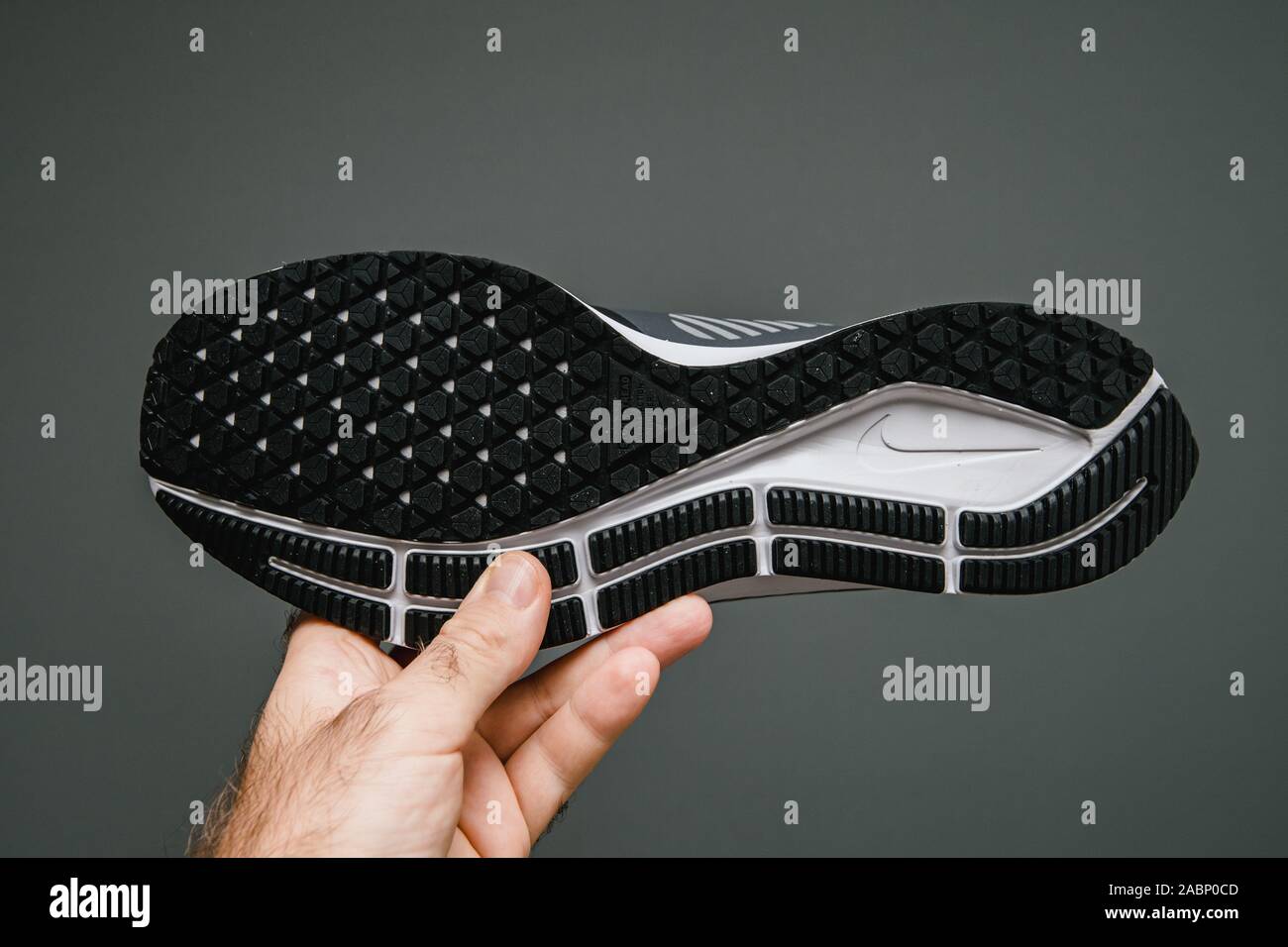 Paris, France - Oct 24, 2019: Man hand holding against gray background new  professional running shoe manufatured by Nike model Air Zoom Pegasus 36  Shield Stock Photo - Alamy