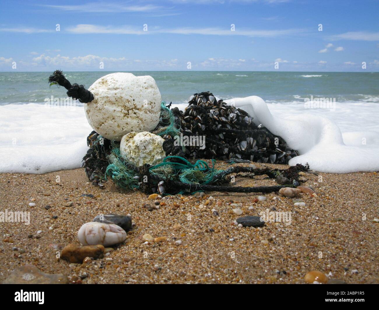 Discarded rubbish, fishing net, floats and debris washed onto the beach Bretignolles-sur-Mer, Vendee, South west France Stock Photo