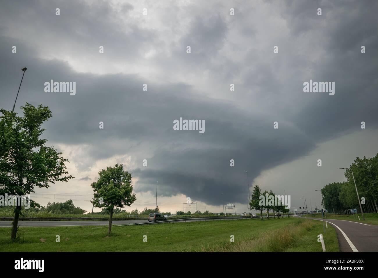 Rotating wallcloud of a supercell thunderstorm over the highway. Torrential rain and large hail were caused by this storm. Stock Photo