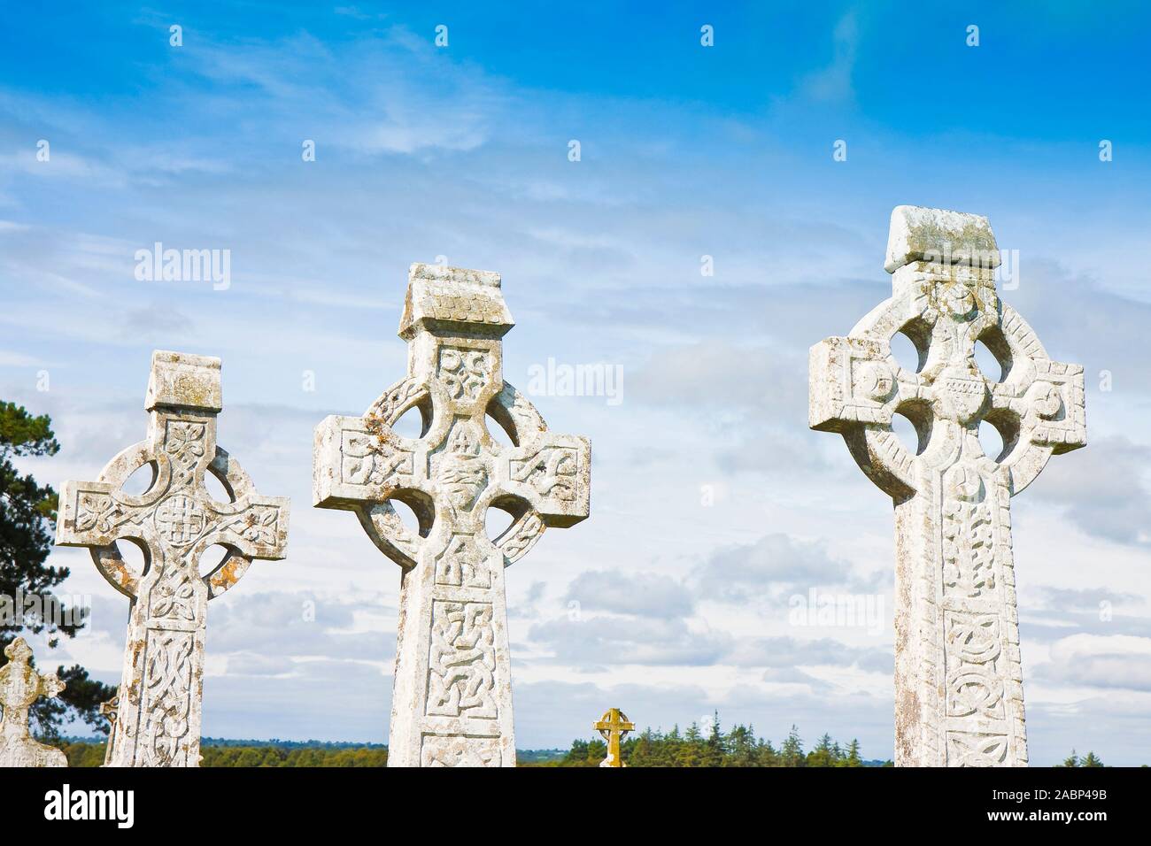 Celtic carved stone cross against a sky background. Stock Photo