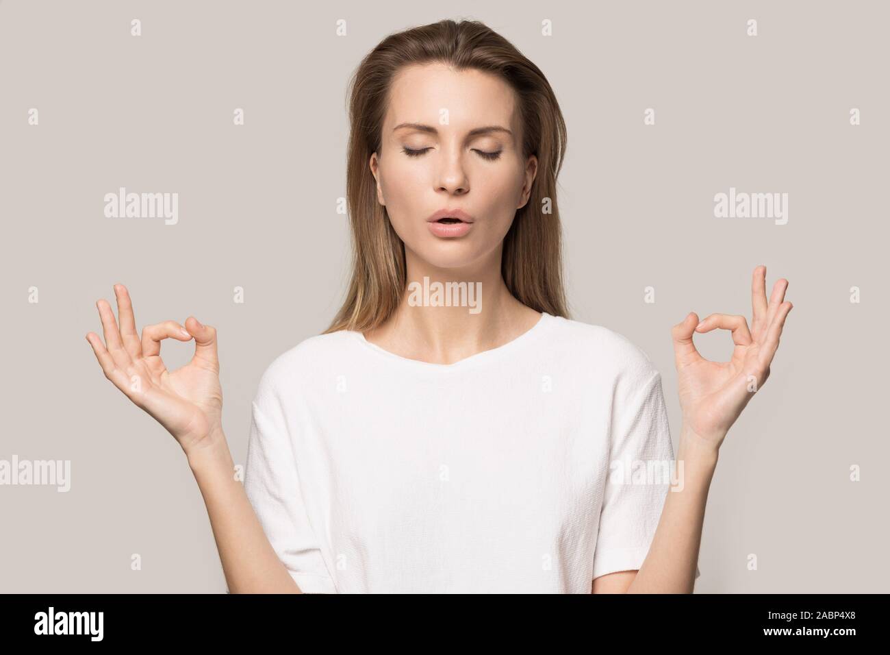 Calm woman relaxing, practicing yoga, meditating with closed eyes Stock ...