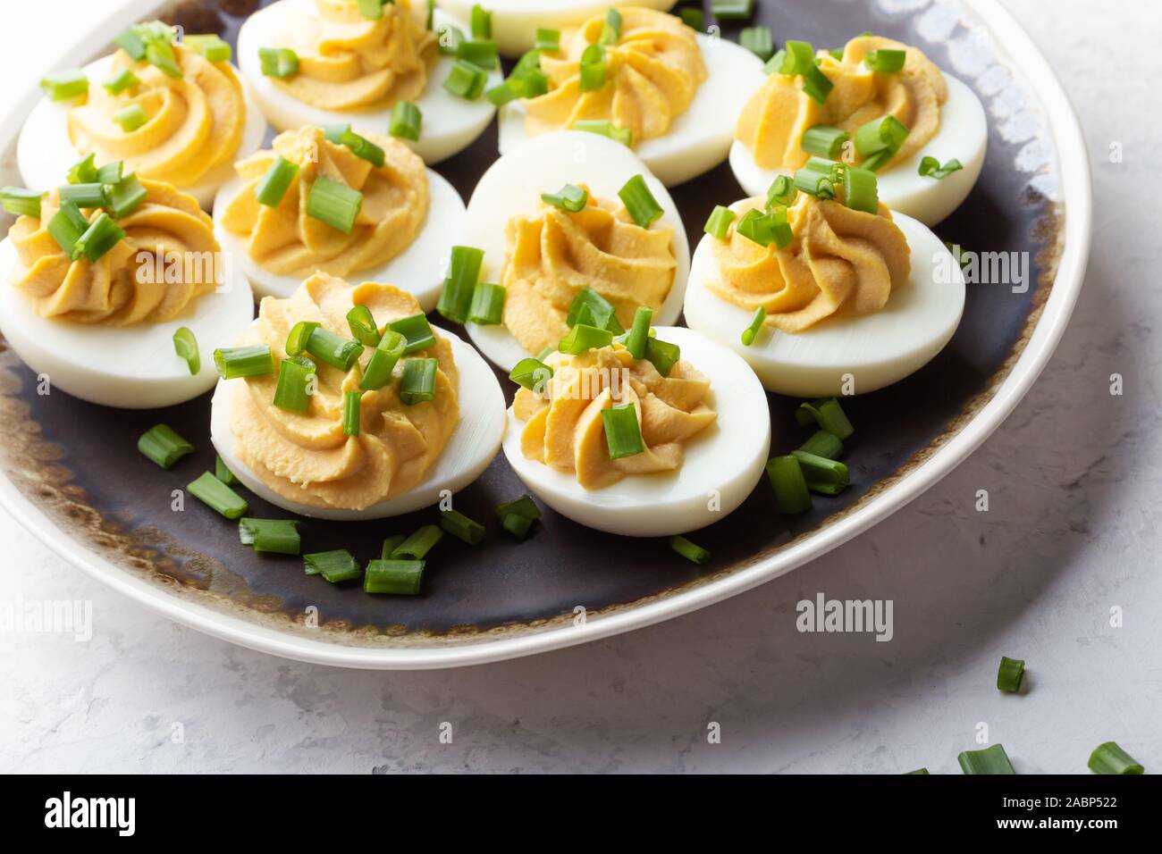 Deviled eggs with green onion, Easter party snack, close up Stock Photo