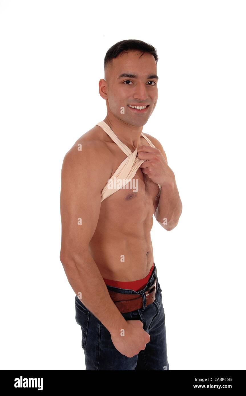A handsome young east Indian man standing shirtless and smiling in jeans with red underwear, isolated for white background Stock Photo