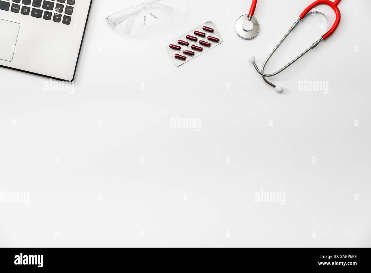 Flat lay on white background, painkillers with glass of water prescribed by a doctor, copy space. Stock Photo