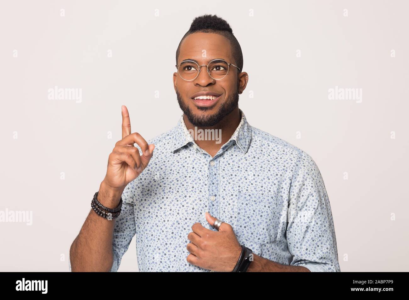 Smiling African American man with raise finger isolated, idea concept Stock Photo
