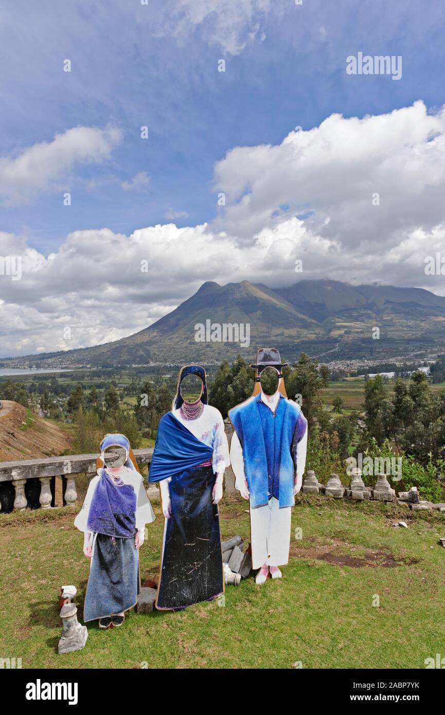 A photo face board cutout of an Ecuadorian family at  Gonzalez Suarez near Otavalo, Ecuador with the Imbabura Volcano in the background Stock Photo