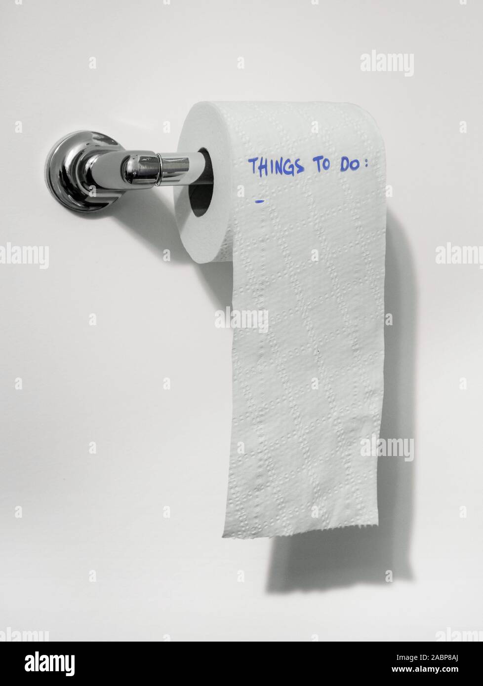 On the toilet paper roll is written: 'things to do'. Copy-space. Stock Photo