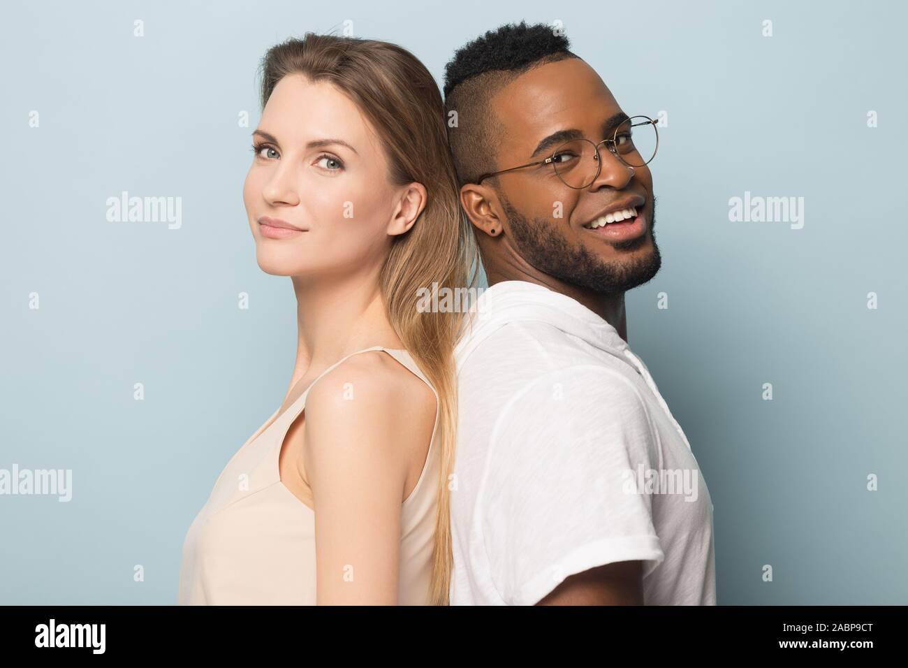 Smiling African American man and woman standing back to back Stock ...