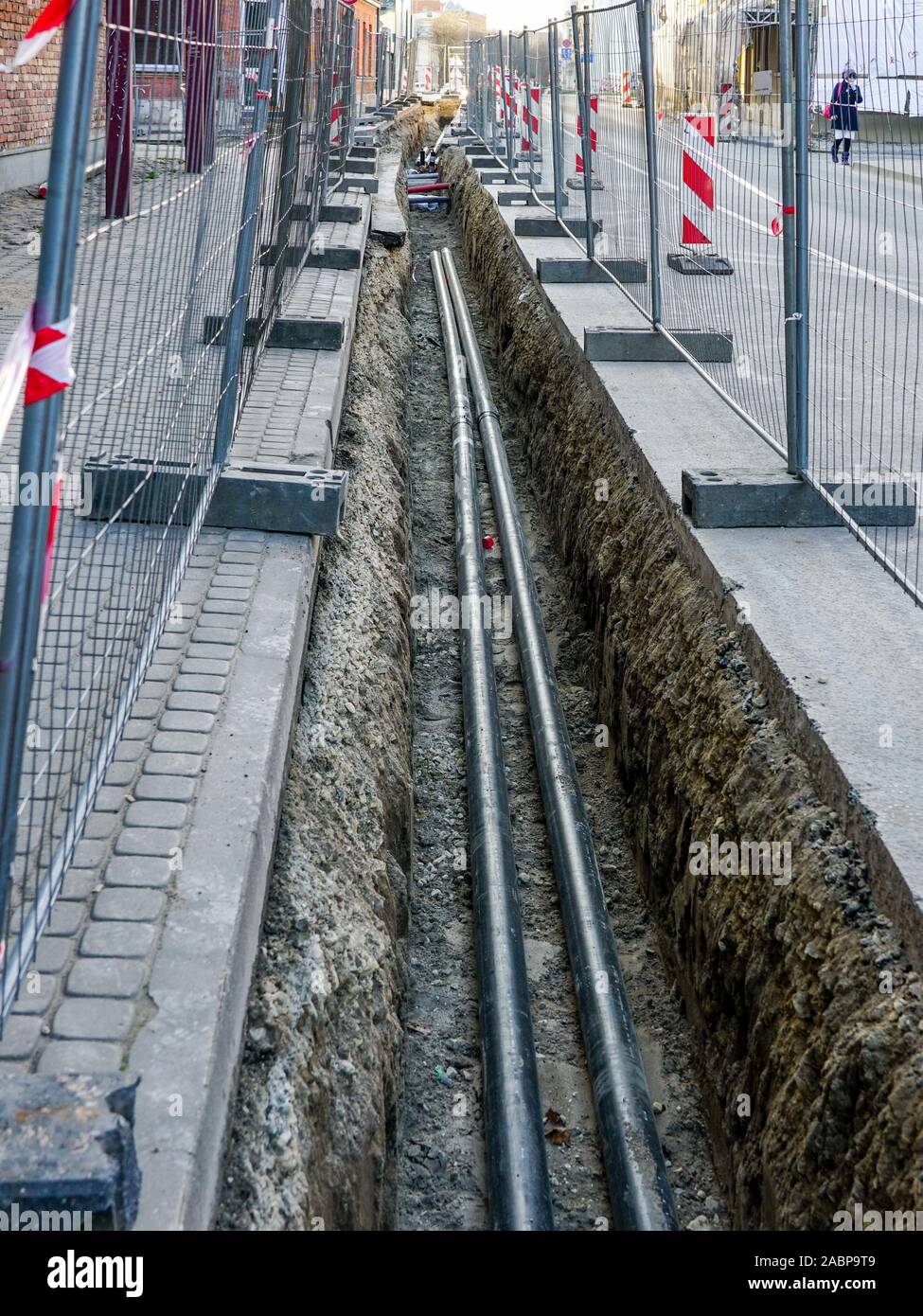 replacement of underground district heating pipes on city street Stock
