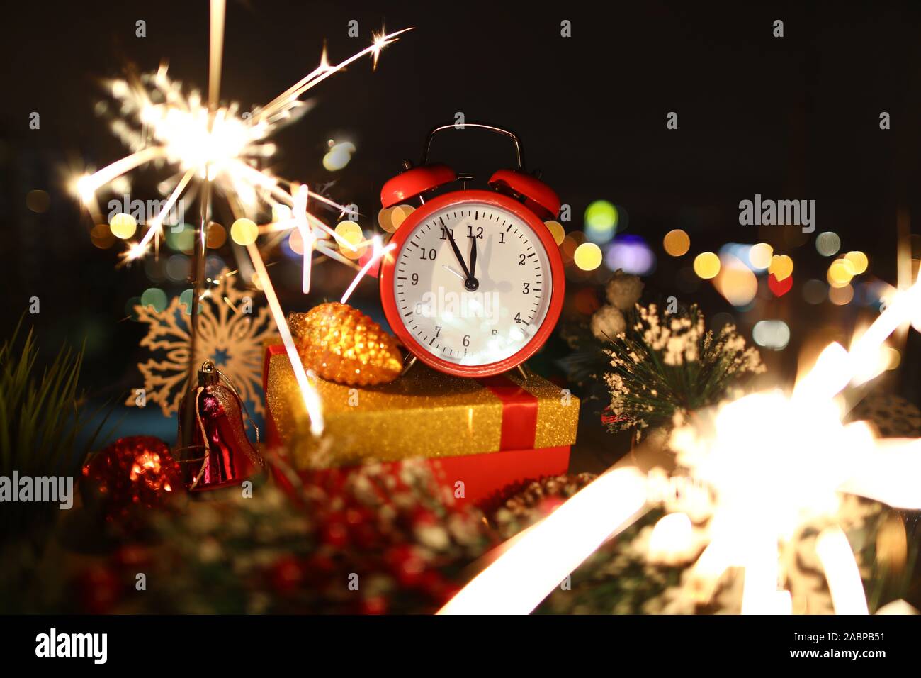 Red alarm clock with christmas gifts against night Stock Photo Alamy