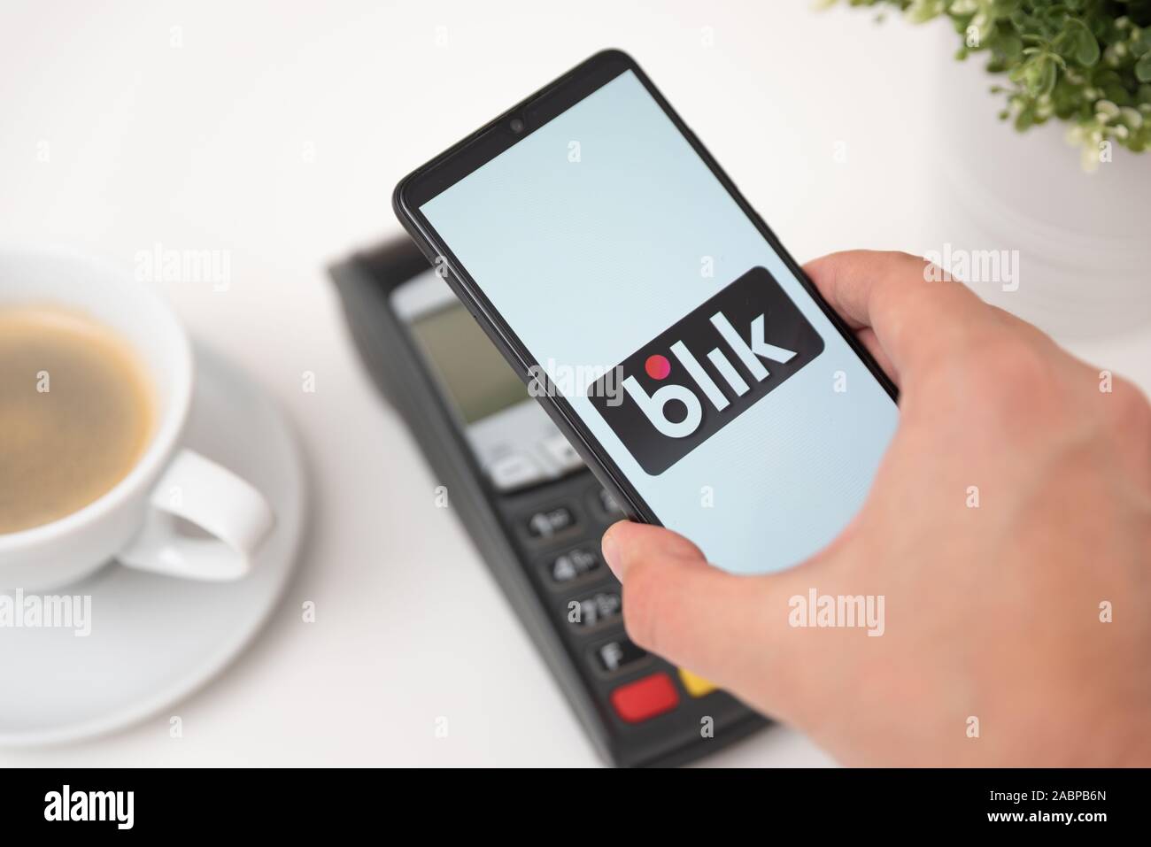 Wroclaw, Poland - NOV 06, 2019: Man holding smartphone with Blik logo, contactless payment. Blik is Polish most popular quick payment method in Poland Stock Photo