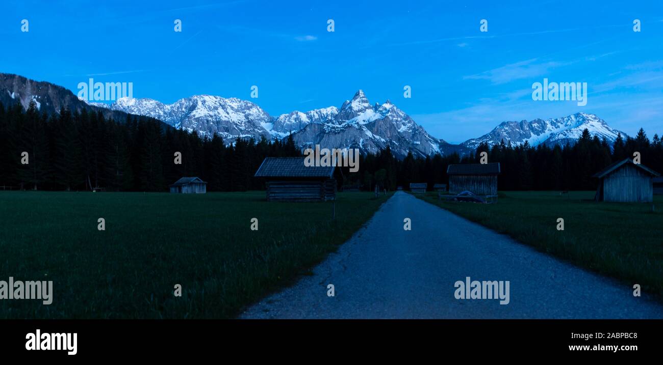 Heustadl in a meadow, Ehrwalder Sonnenspitz and mountains at night, near Ehrwald, Tyrol, Austria Stock Photo