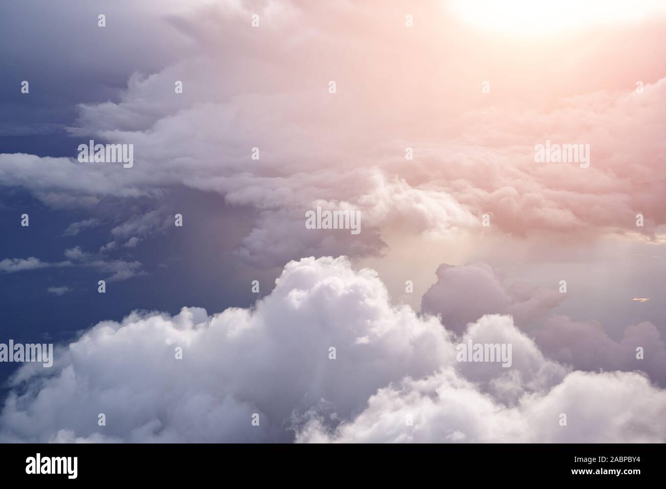 Aerial view from the plane of white soft fluffy clouds over the green ...